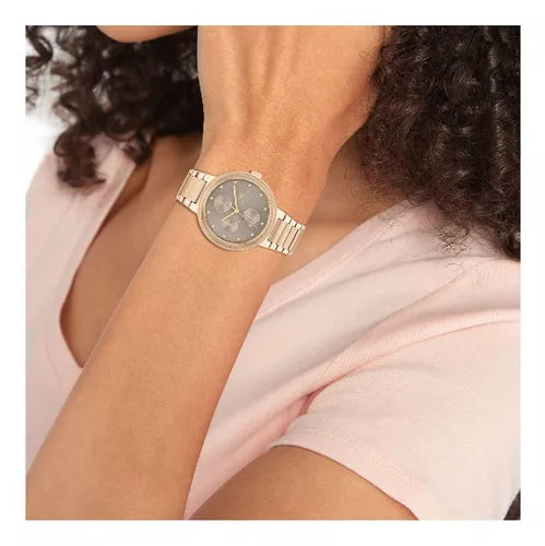 Tommy Hilfiger Joy chronograph watch worn on wrist with gold dial and bracelet