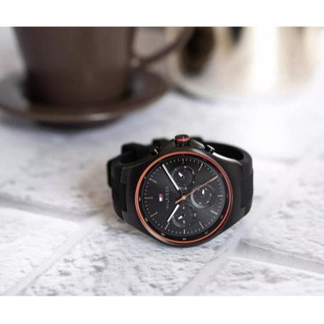 Tommy Hilfiger Justin black chronograph watch with red bezel detail on surface
