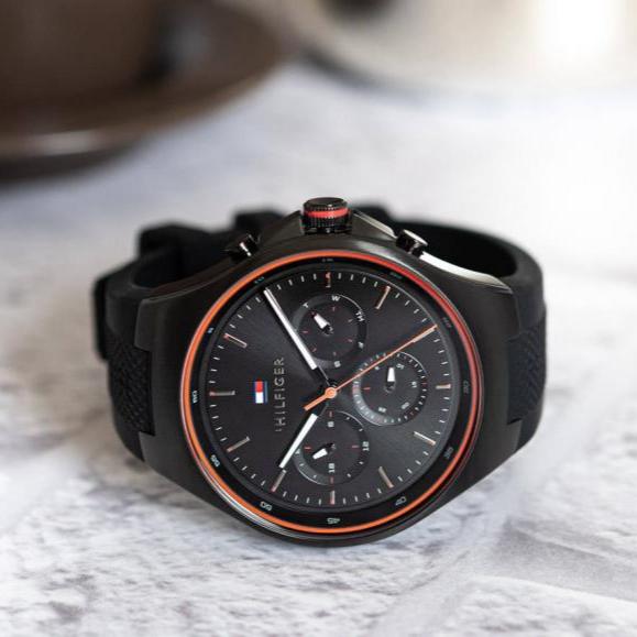 Tommy Hilfiger Justin black chronograph watch with red accents on marble surface