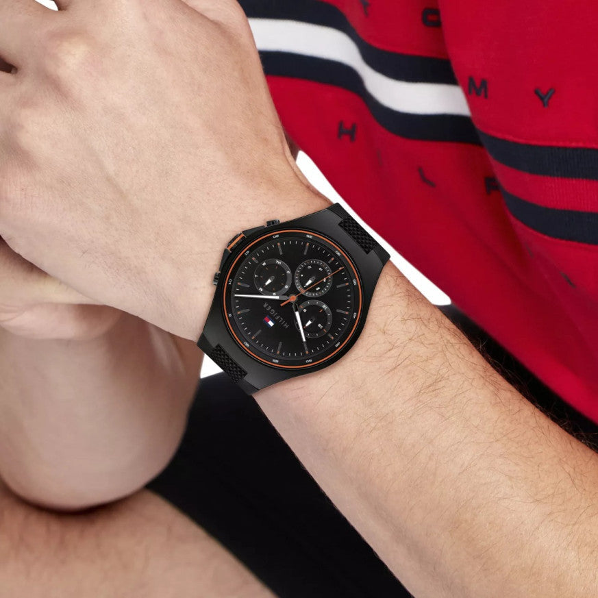 Tommy Hilfiger Justin chronograph watch worn on wrist with red striped clothing