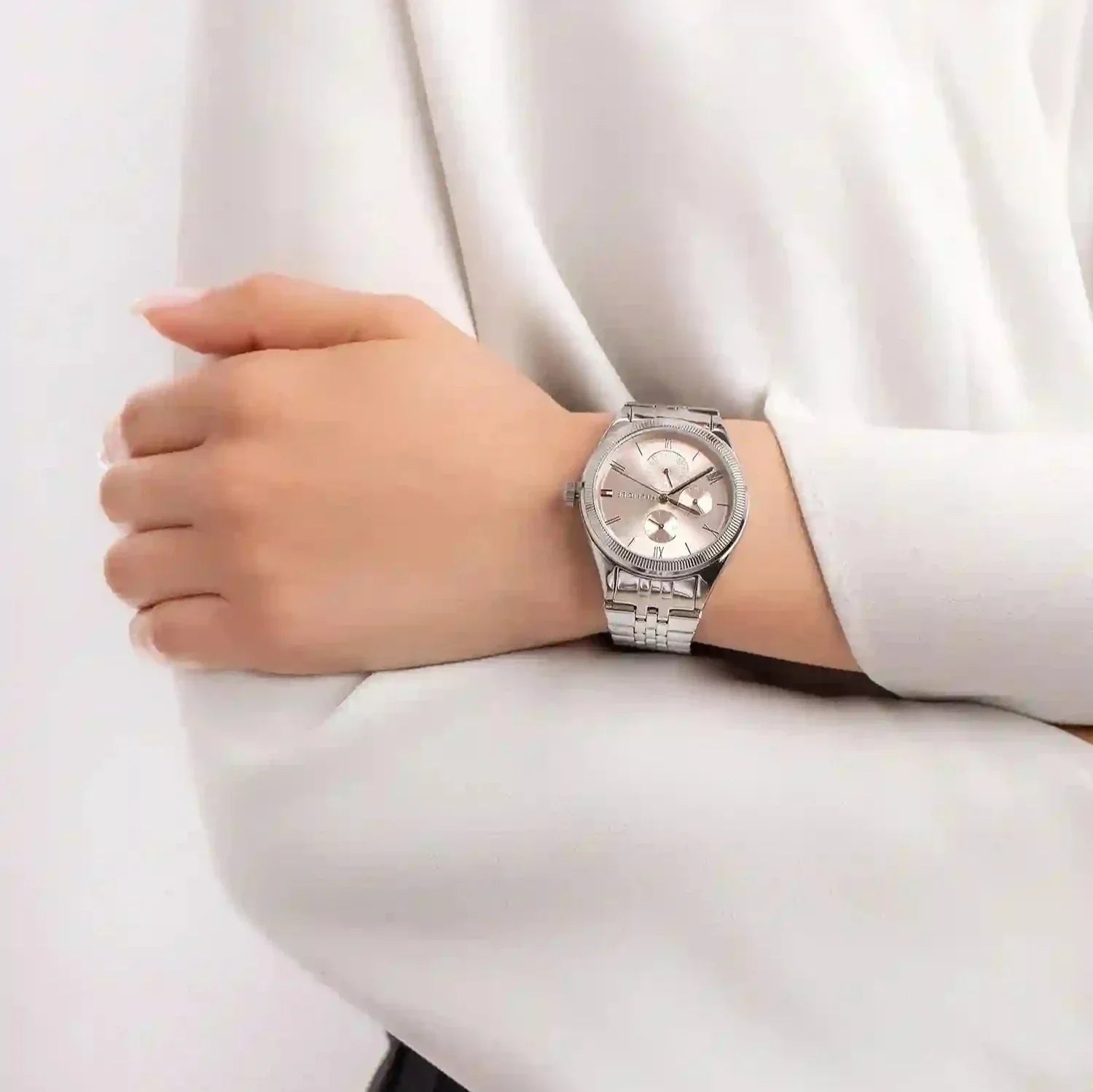 Tommy Hilfiger Monica chronograph watch worn on wrist with pink dial and silver strap