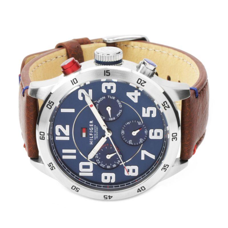 Close-up of blue dial showing multi-function subdials and white numerals on Tommy Hilfiger watch