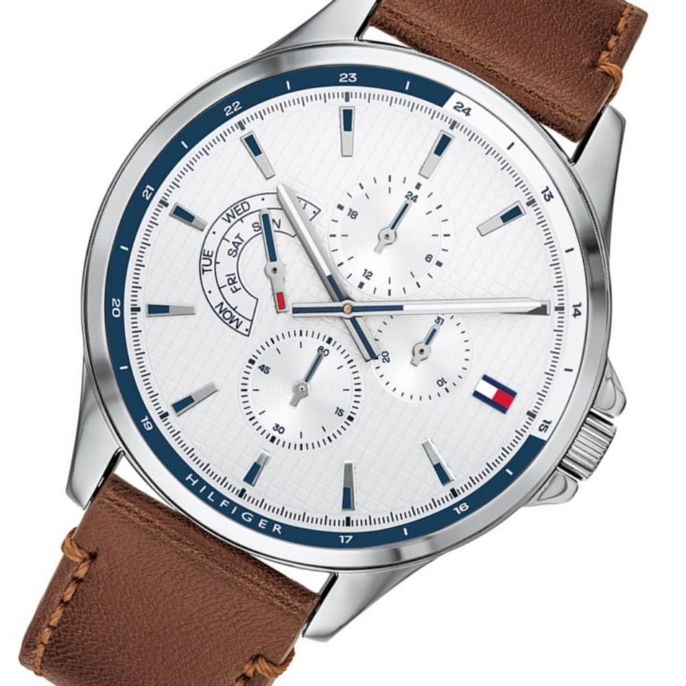 Angled view of Tommy Hilfiger watch showing white dial with chronograph subdials