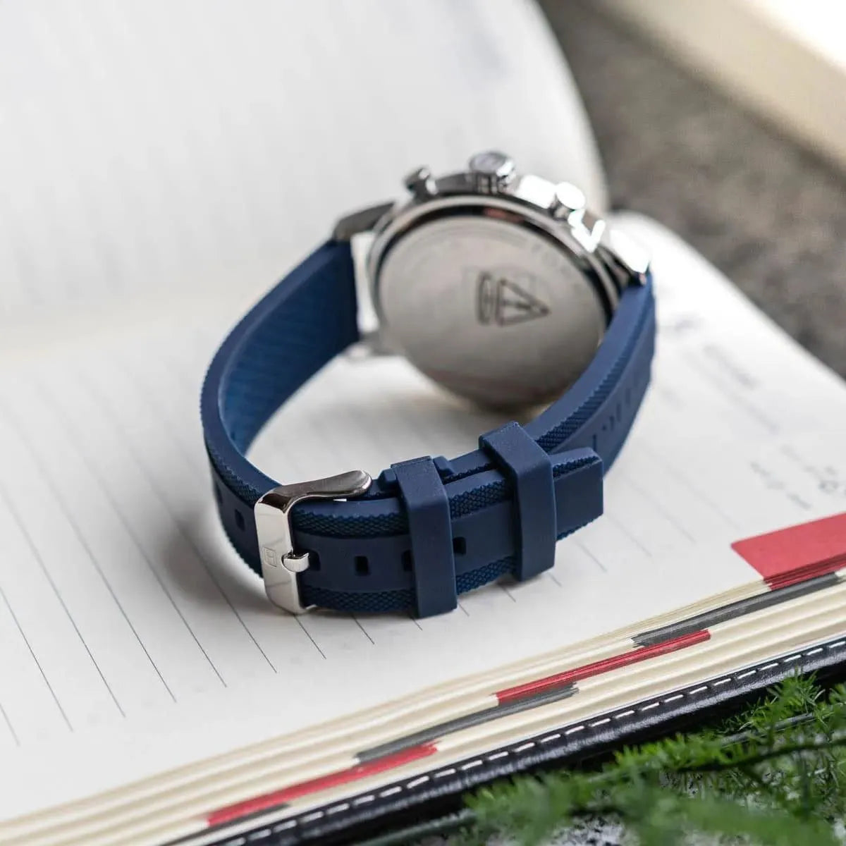 Back of Tommy Hilfiger Rocky watch showing caseback with Tommy Hilfiger logo on navy rubber strap