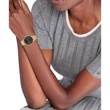 Tommy Hilfiger TEA gold watch worn on wrist with black dial