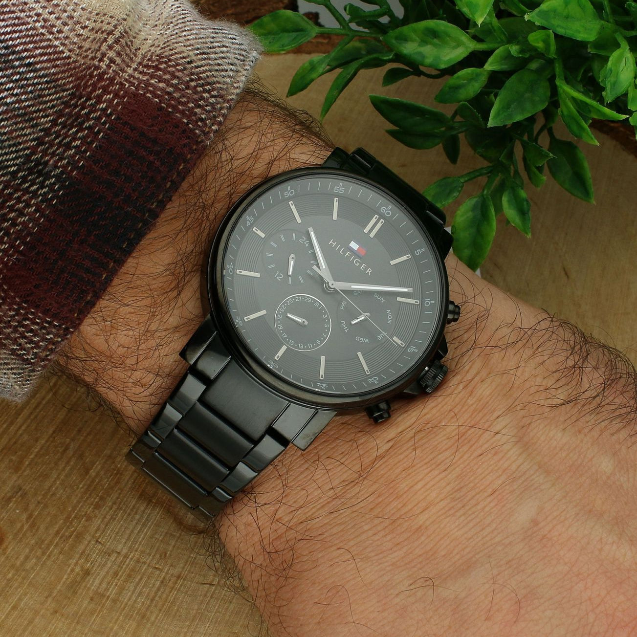 Tommy Hilfiger TYSON black chronograph watch worn on wrist with dark dial and steel band