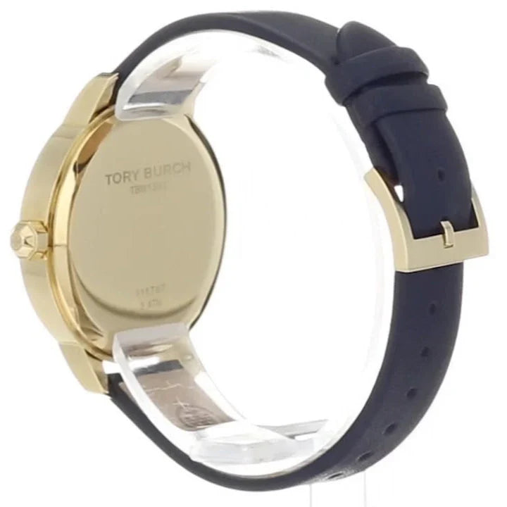Caseback view of Tory Burch Collins watch showing gold-tone case and navy leather strap
