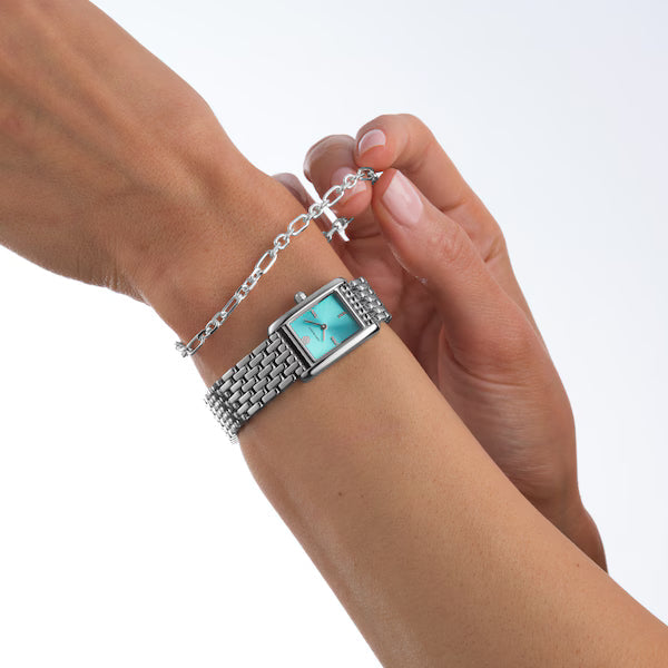 Tory Burch Eleanor watch worn on wrist with silver-tone bracelet
