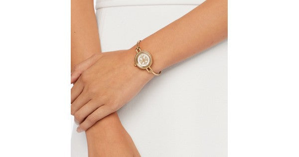 Tory Burch Riva rose gold bangle watch worn on woman's wrist