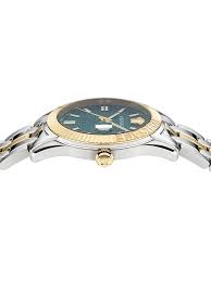 Versace Greca Time watch worn on wrist showing green dial and two-tone design