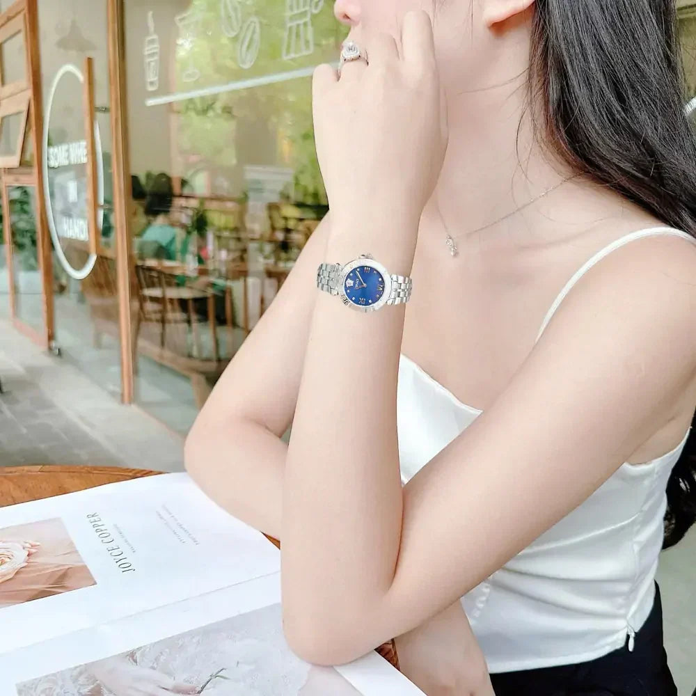 Versace Daphnis watch worn on wrist showing blue dial and silver steel bracelet