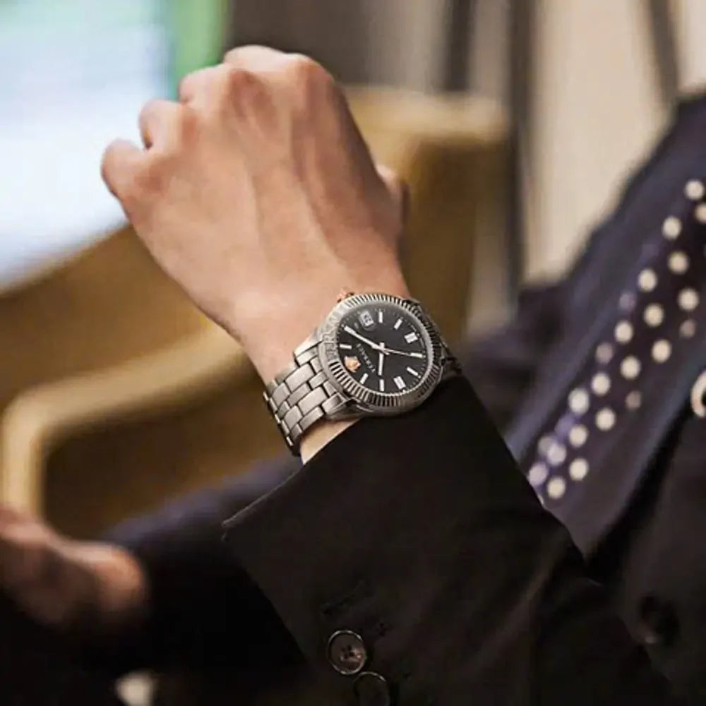 Versace Greca Time watch on wrist showing black dial and stainless steel bracelet in wear