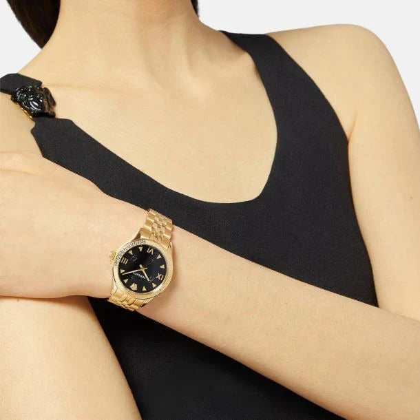 Versace Hellenyium watch worn on woman's wrist with gold-tone bracelet