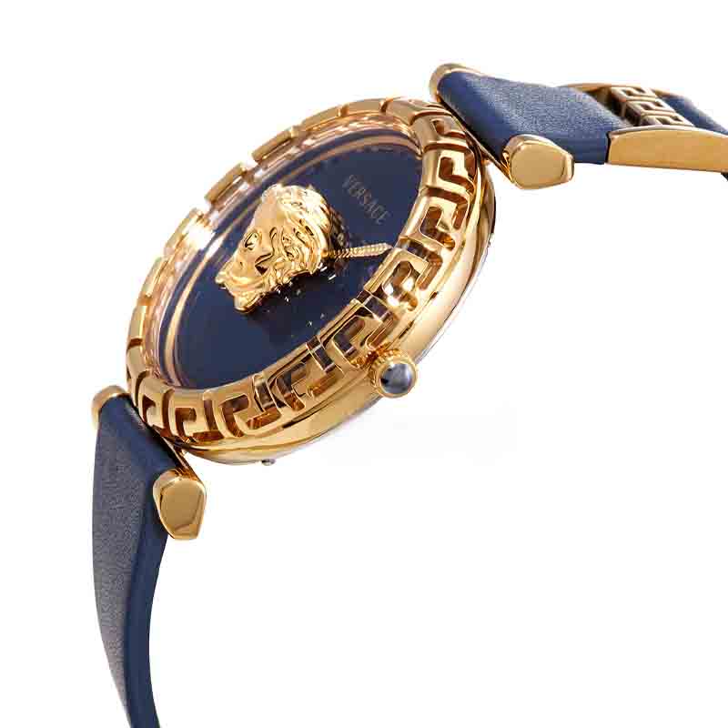 Angled view of Versace Palazzo Empire Greca watch with gold case, blue dial, Medusa motif, and navy leather strap on wrist