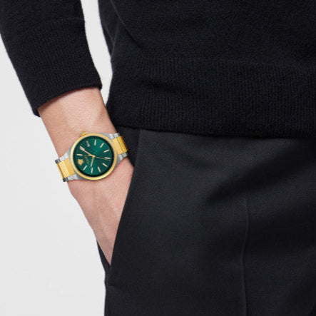 Versace V-Auria worn on wrist showing two-tone strap and green dial