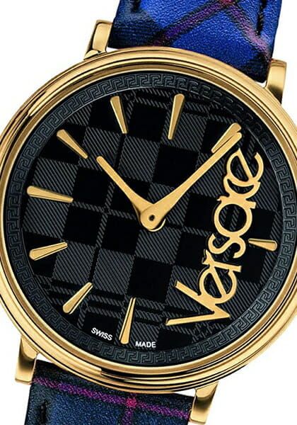 Versace V-Circle dial detail showing black dial with gold indices, gold hands and Versace script