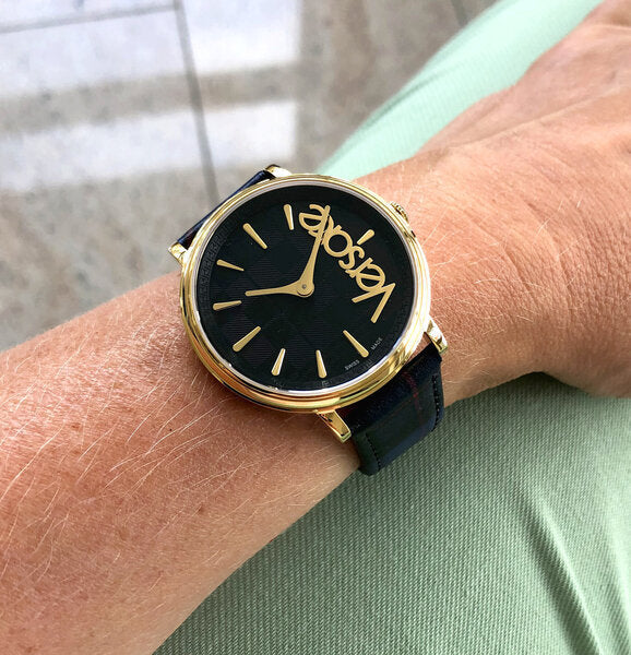 Versace V-Circle black dial watch worn on wrist with blue leather strap