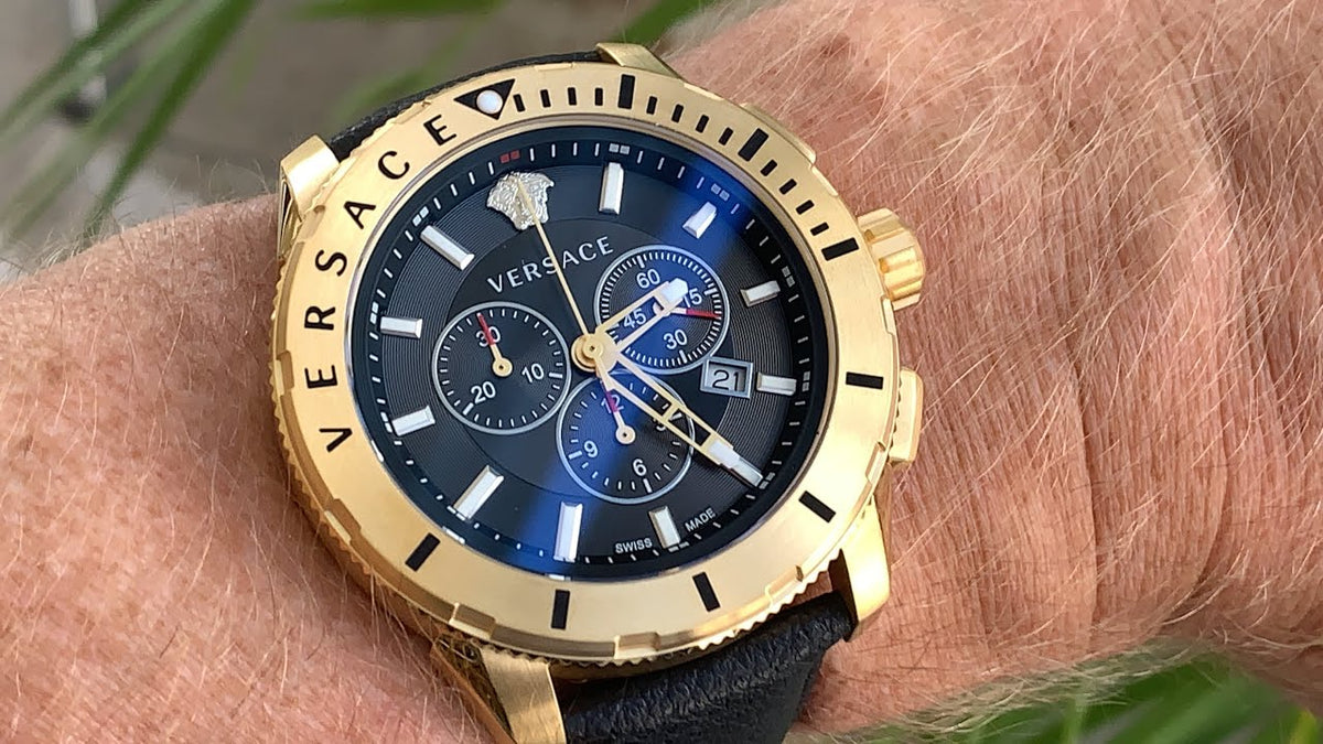 Versace VERG003-18 chronograph watch worn on wrist showing gold case and black dial
