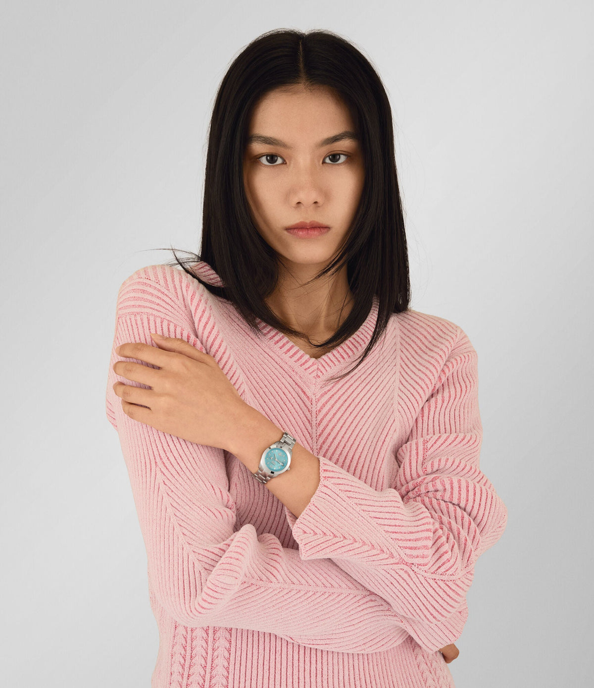 Vivienne Westwood Fenchurch ladies watch worn on wrist with turquoise dial and silver bracelet