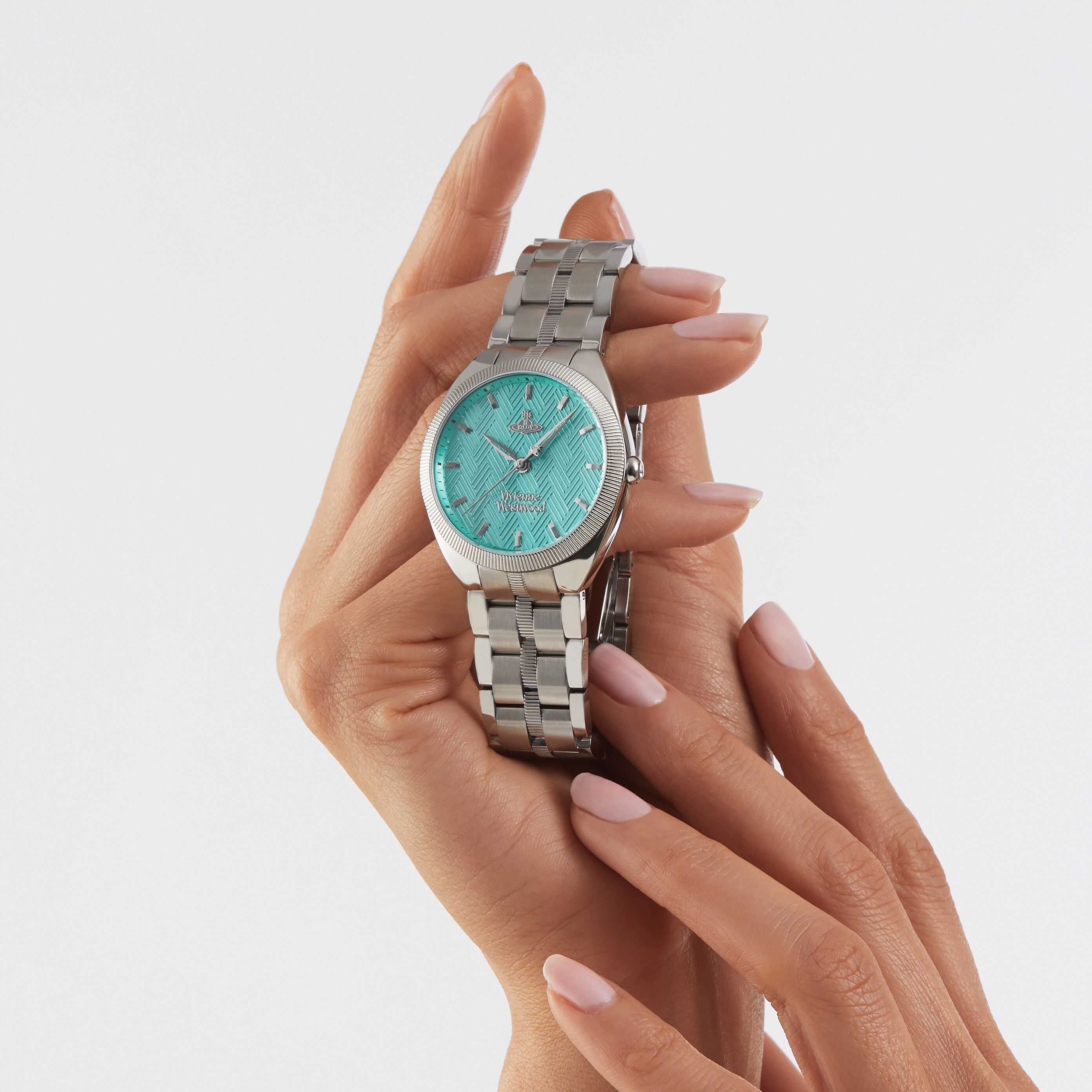 Vivienne Westwood Orb Pop turquoise dial watch on wrist, worn view