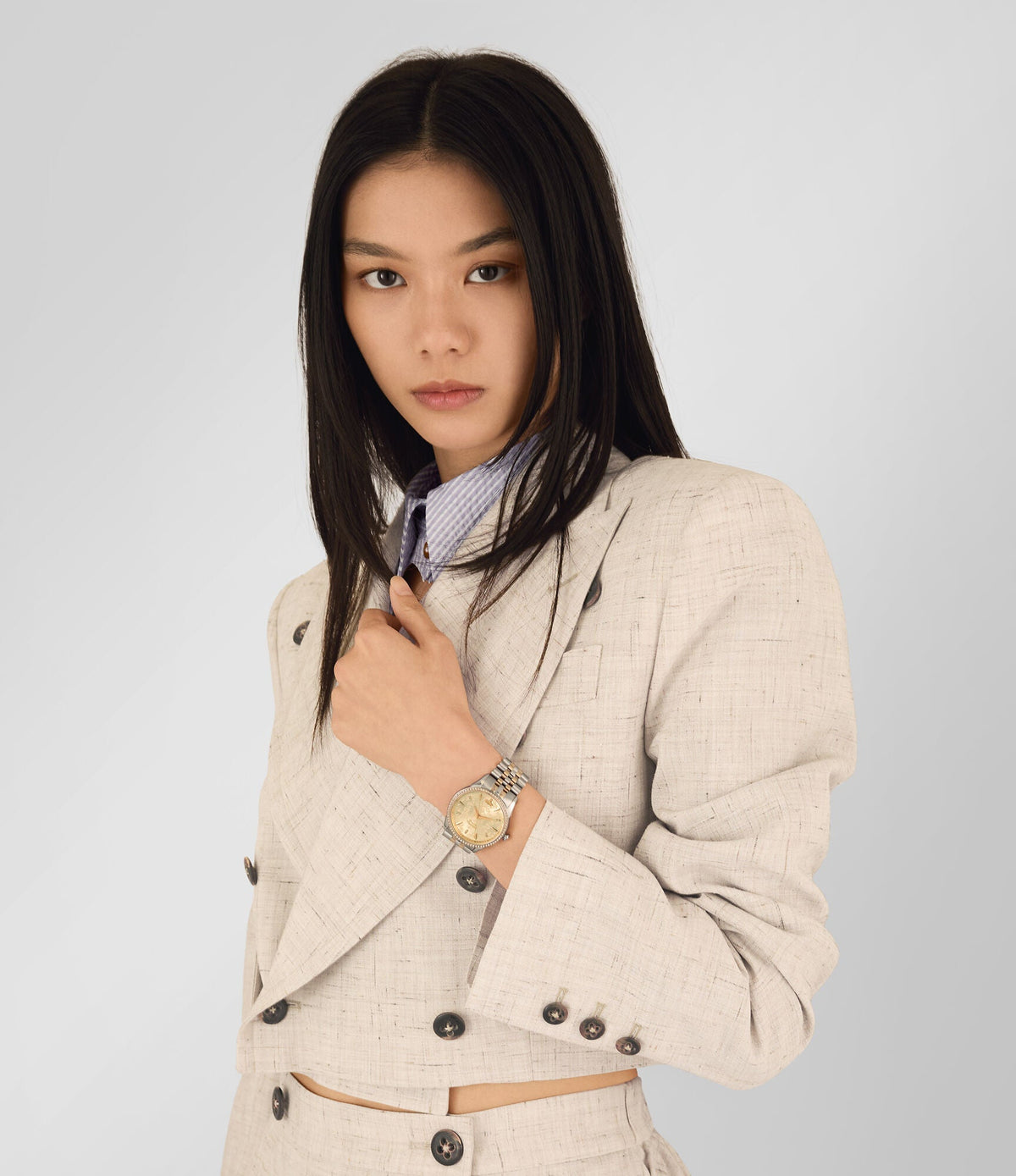 Woman wearing Vivienne Westwood VV208CPSG watch on wrist with two-tone bracelet