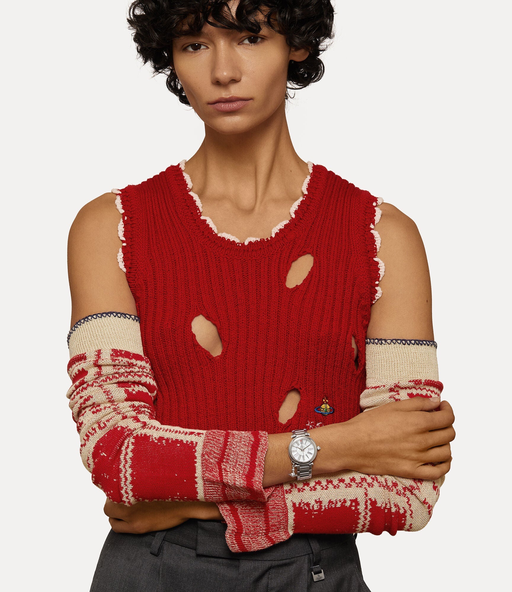 Mother Orb silver watch worn on wrist with red knit sweater