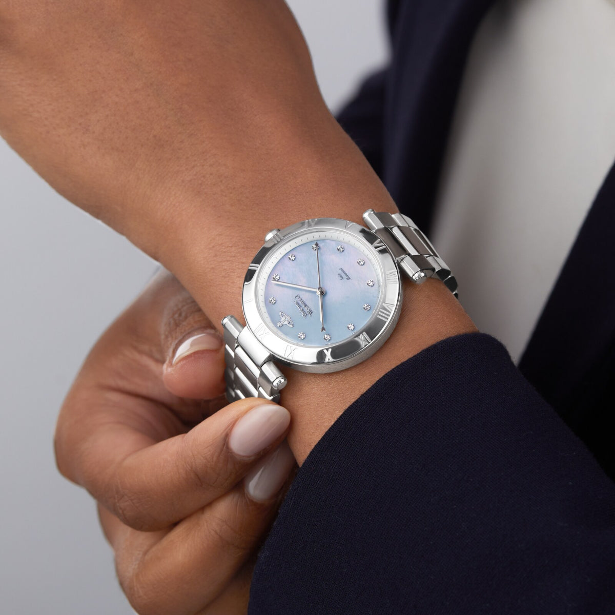 Vivienne Westwood Montagu watch worn on wrist showing light blue dial and crystal indices