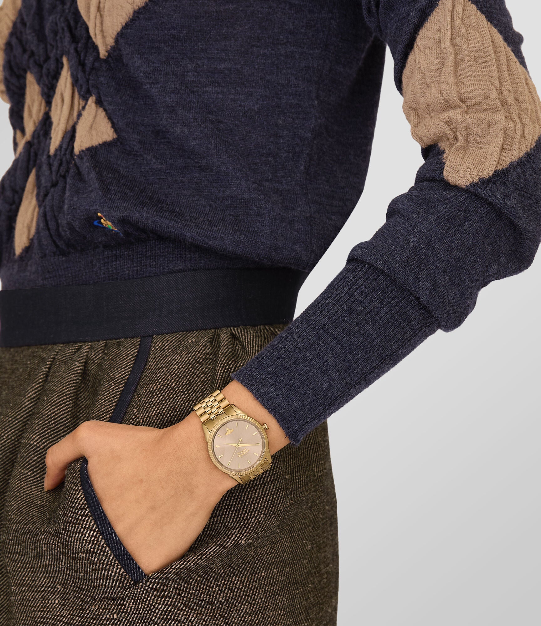 Vivienne Westwood Seymour 38mm watch on wrist showing champagne face and gold bracelet detail