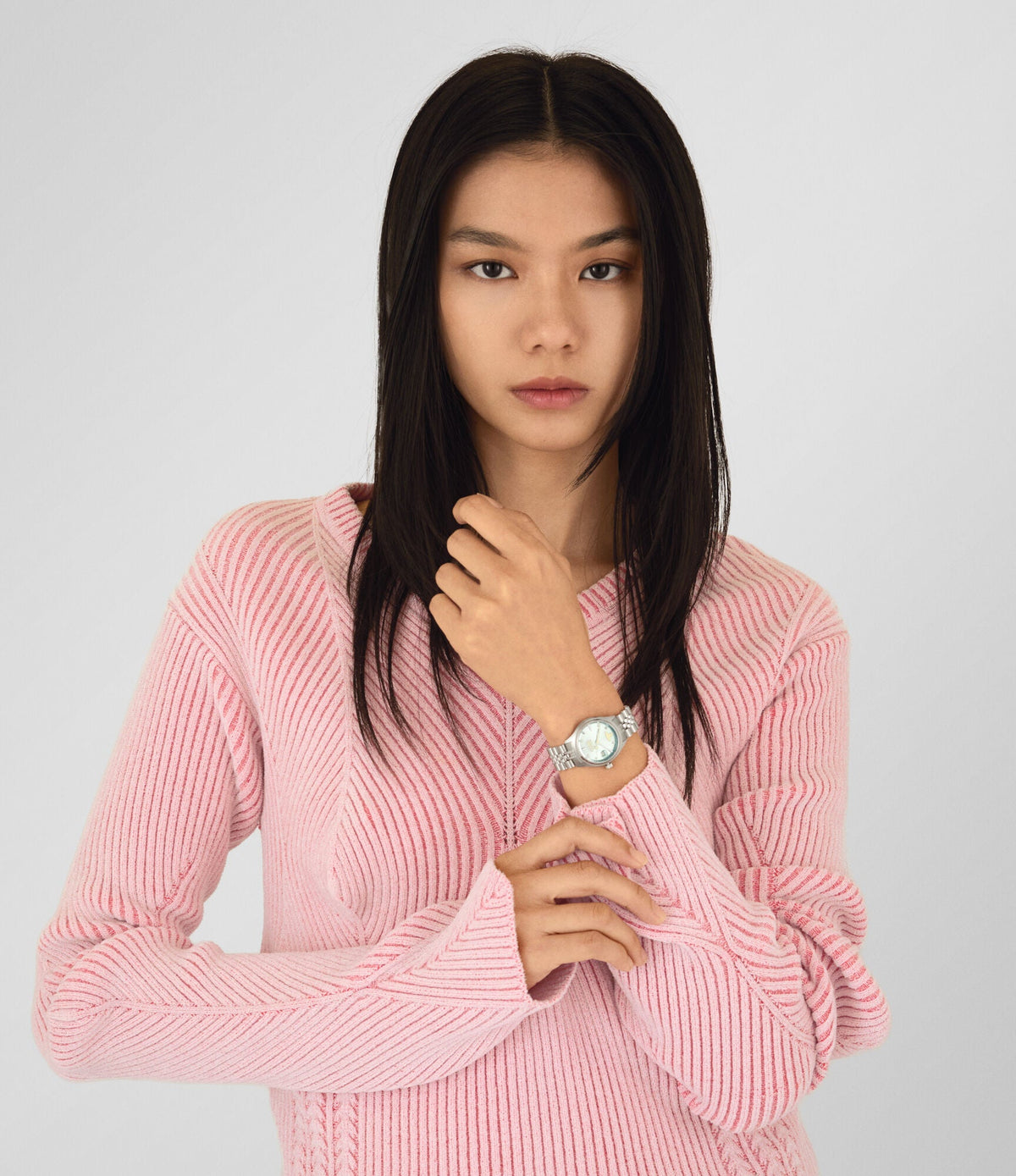 Vivienne Westwood Bloomsbury watch on wrist, worn with pink ribbed sweater