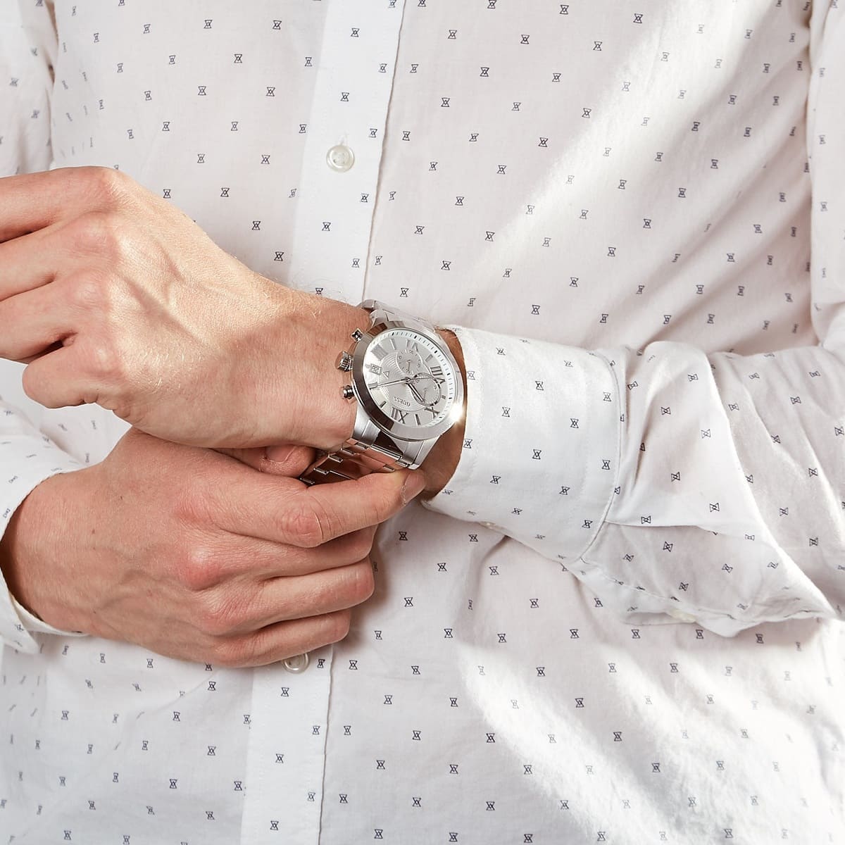 GUESS W0668G7 watch worn on wrist with brown leather belt and white shirt