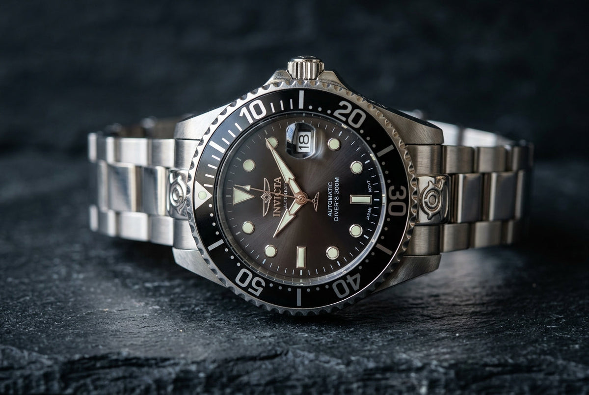 A black and silver watch displayed on a sleek black surface, highlighting its elegant design and craftsmanship.