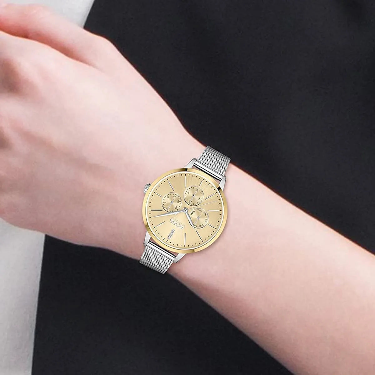 Hugo Boss Symphony gold dial watch worn on wrist with silver mesh bracelet