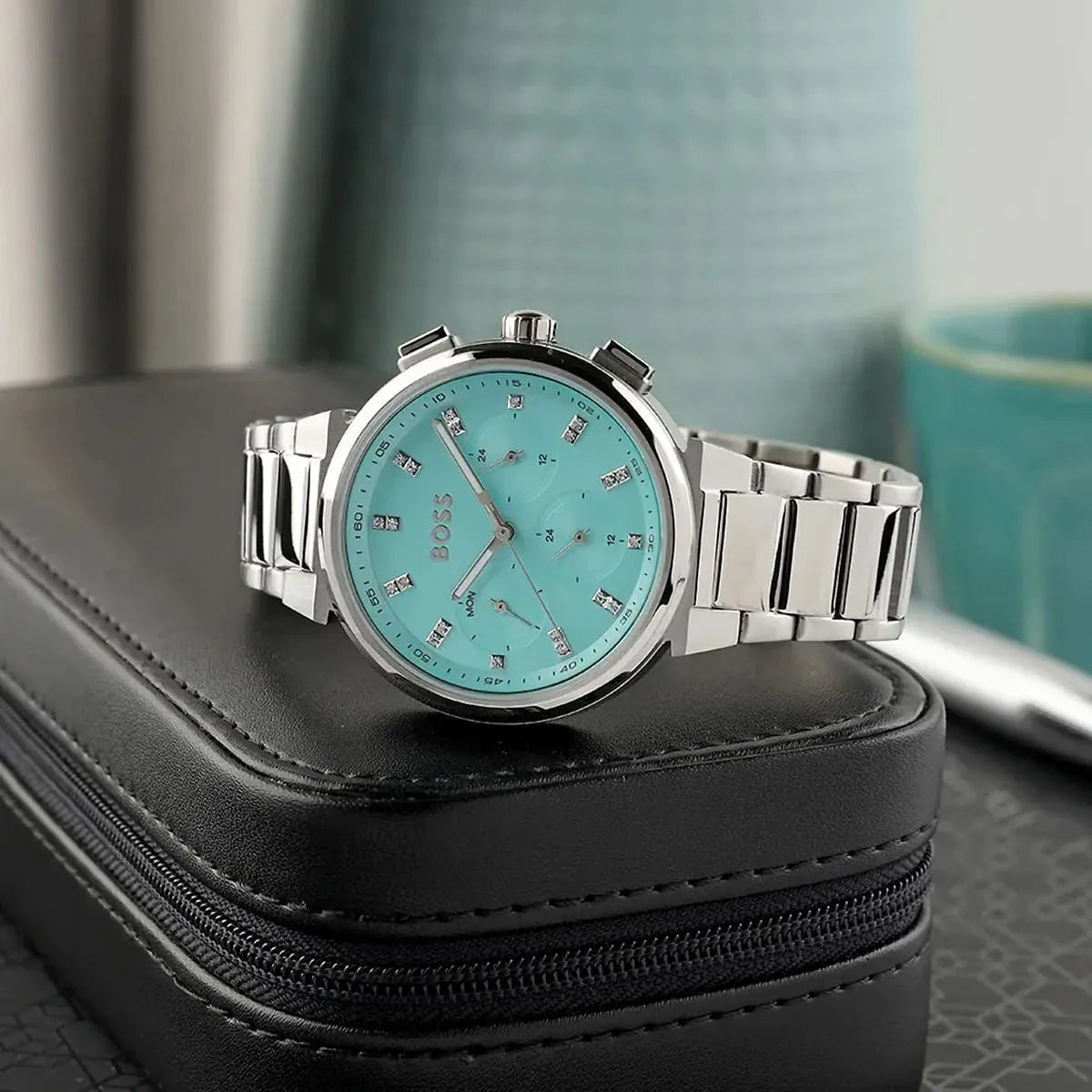 Hugo Boss Candor women's watch displayed on black storage case with turquoise dial