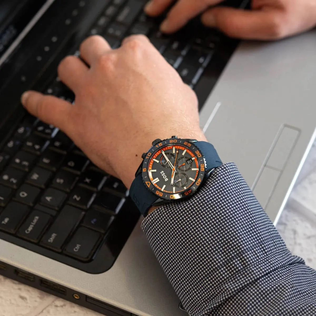 Hugo Boss Runner chronograph watch on wrist with blue strap, displaying time and chronograph dial