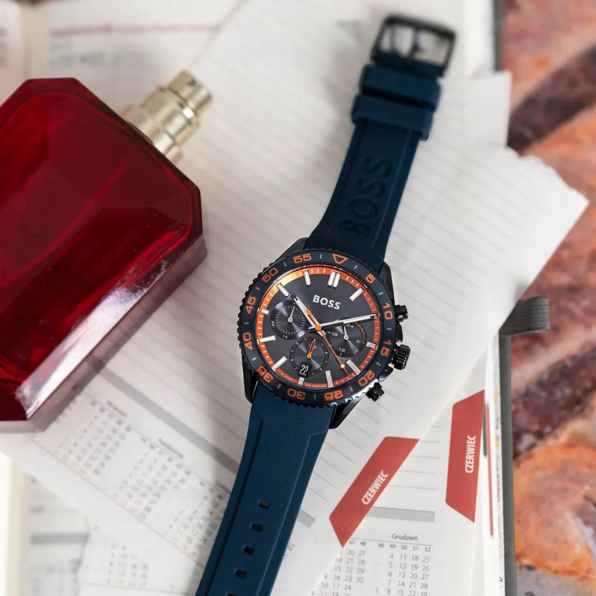 Hugo Boss Runner watch worn on wrist showing blue dial with orange bezel and chronograph subdials