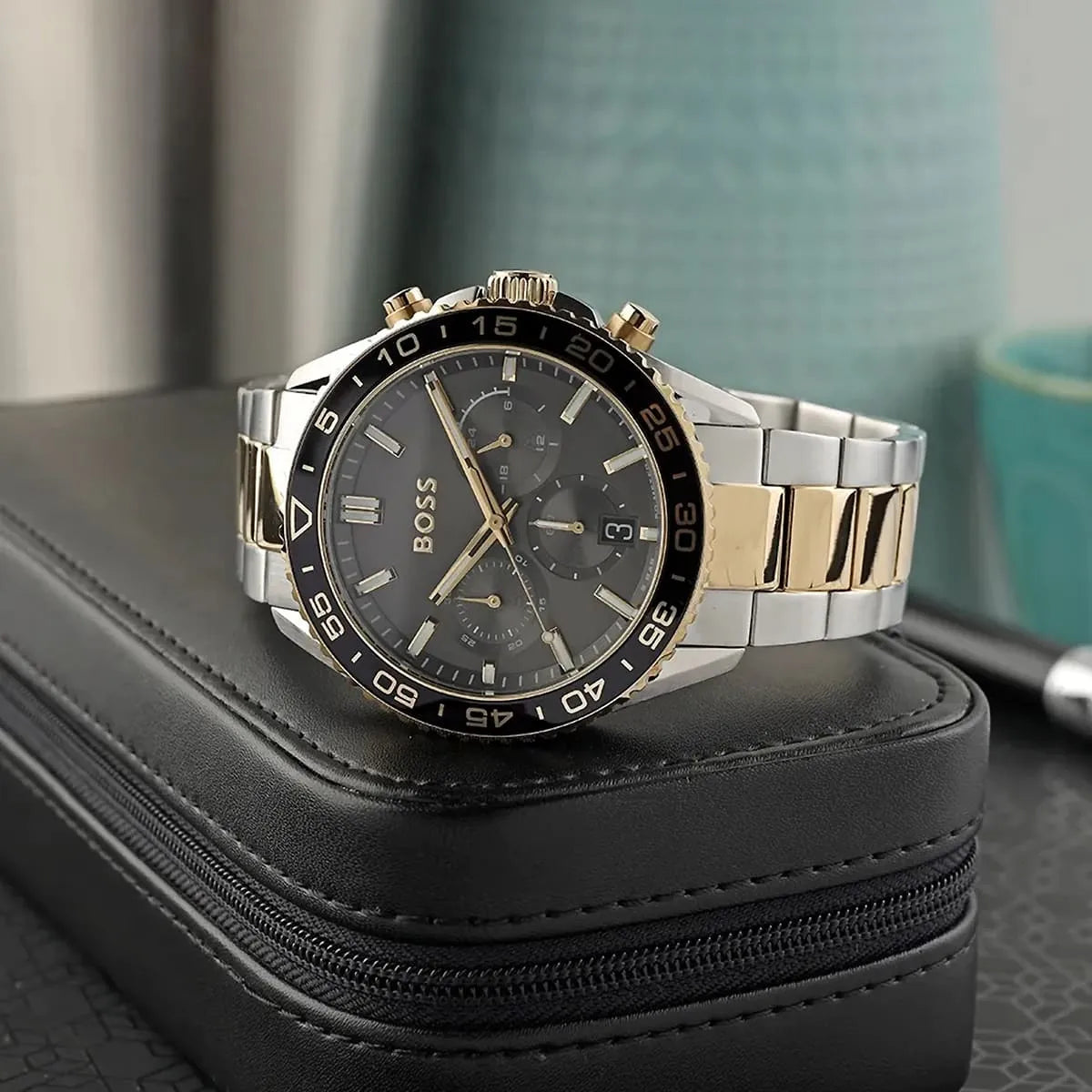 Hugo Boss Runner Chronograph watch on black leather case with turquoise background
