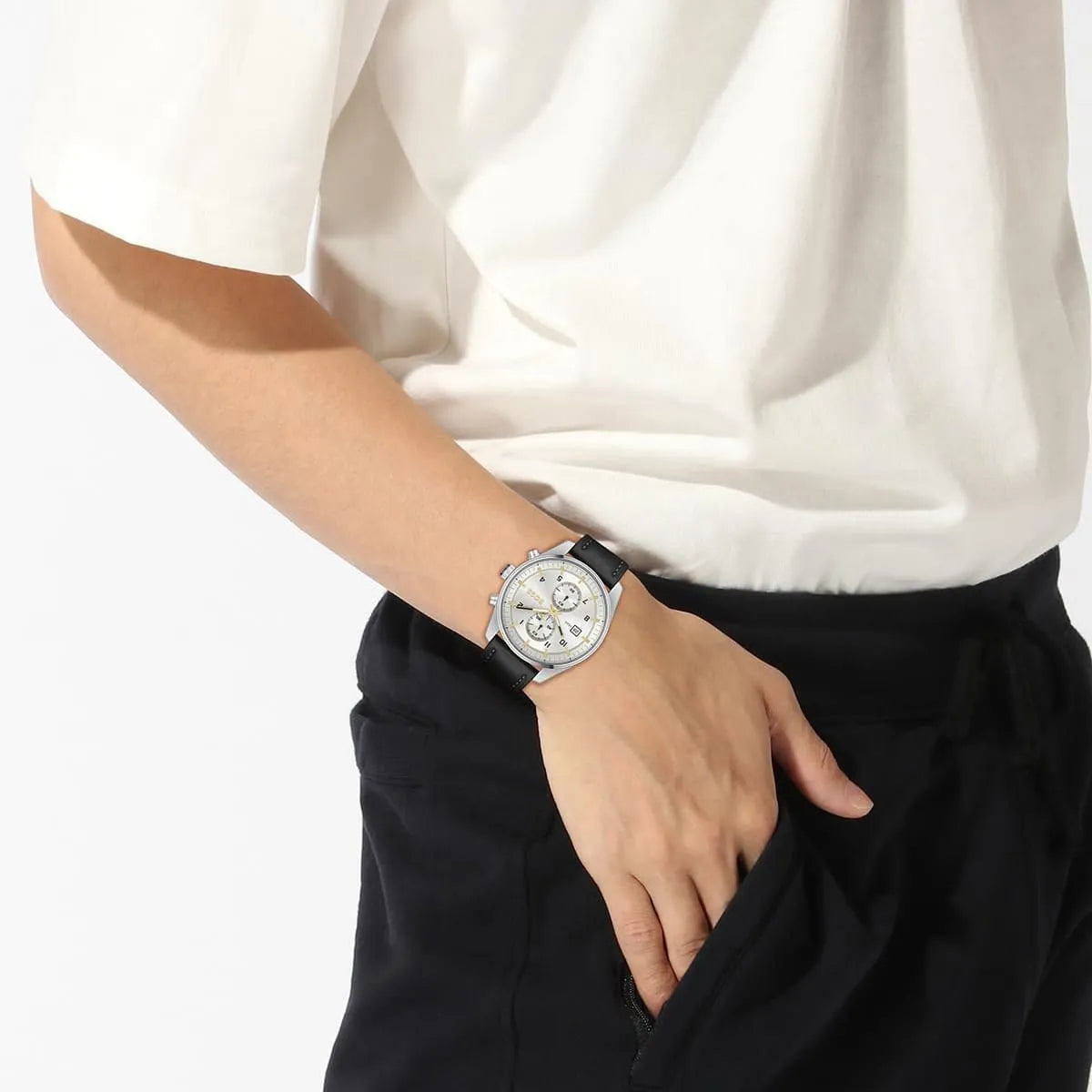 Hugo Boss Skymaster watch worn on wrist with white sleeve and black trousers