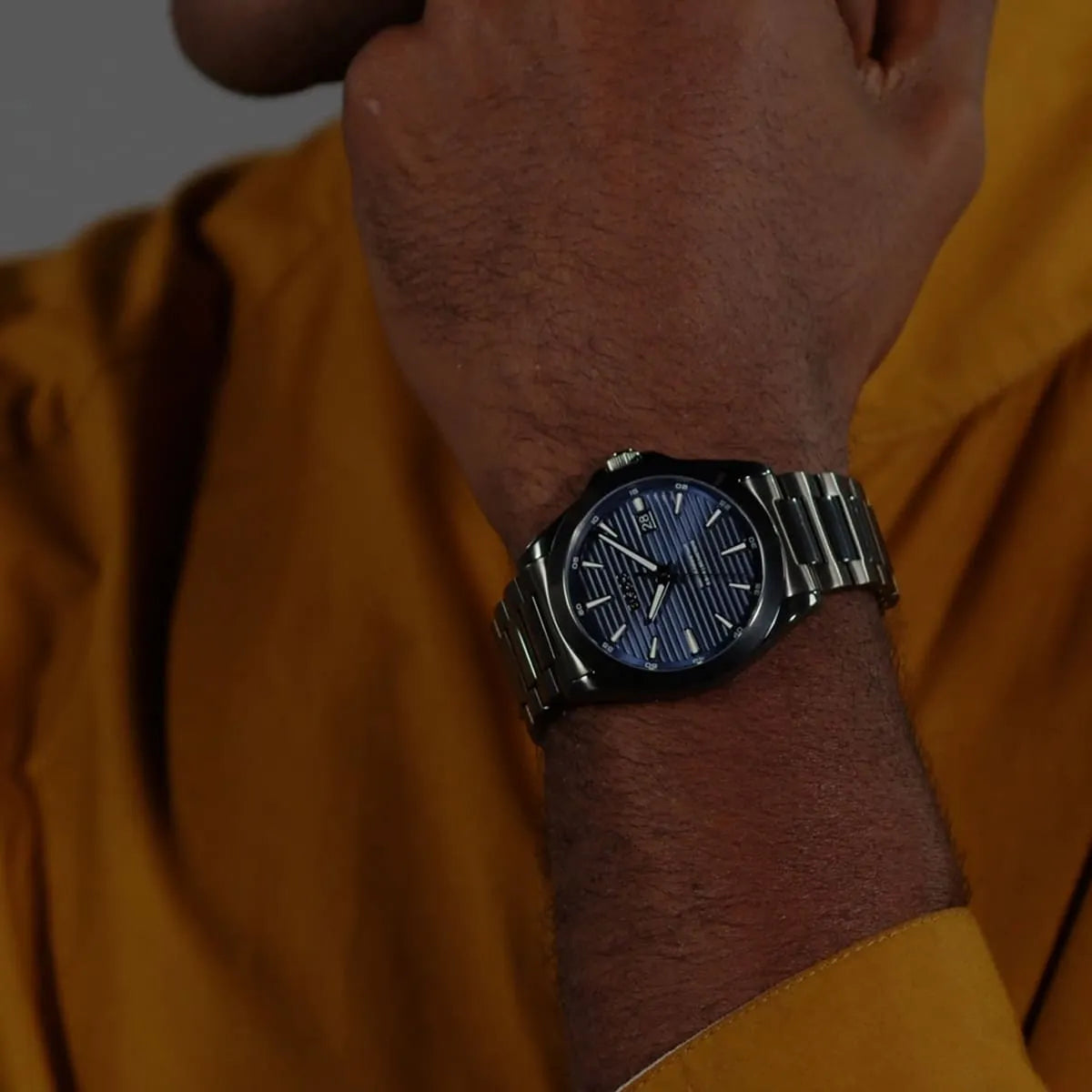 Hugo Boss Strike watch on wrist showing blue striped dial and gray steel case