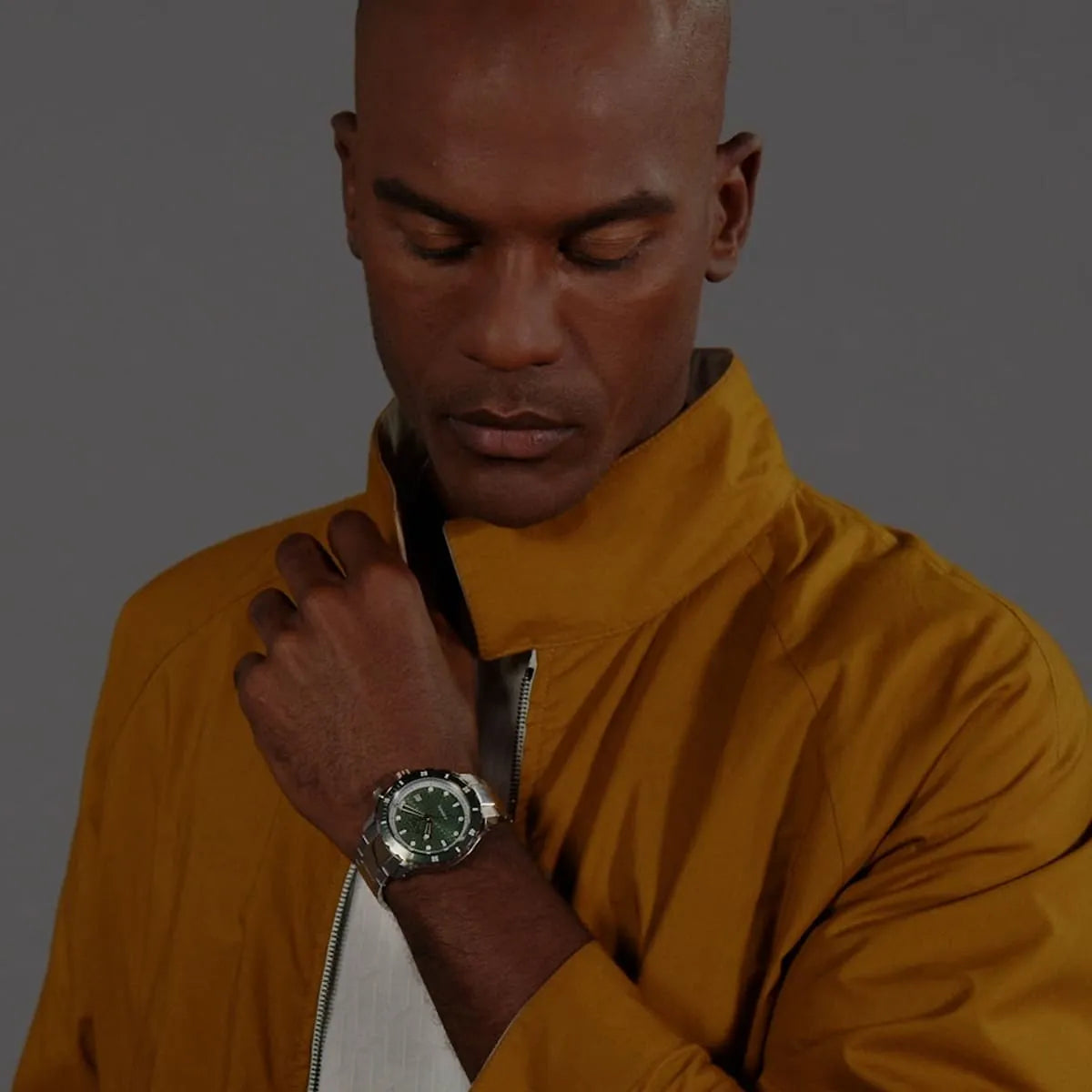 Hugo Boss Bossmatic men's watch on wrist with green dial, date window, and automatic movement visible