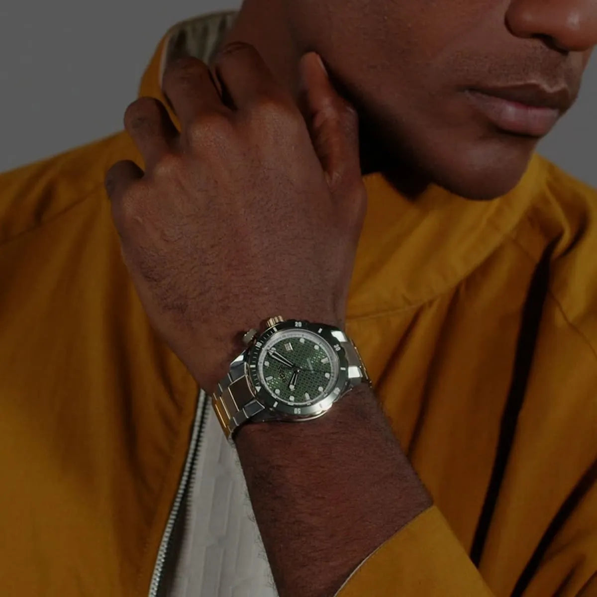 Hugo Boss Bossmatic automatic watch worn on wrist showing green dial and mixed metal bracelet