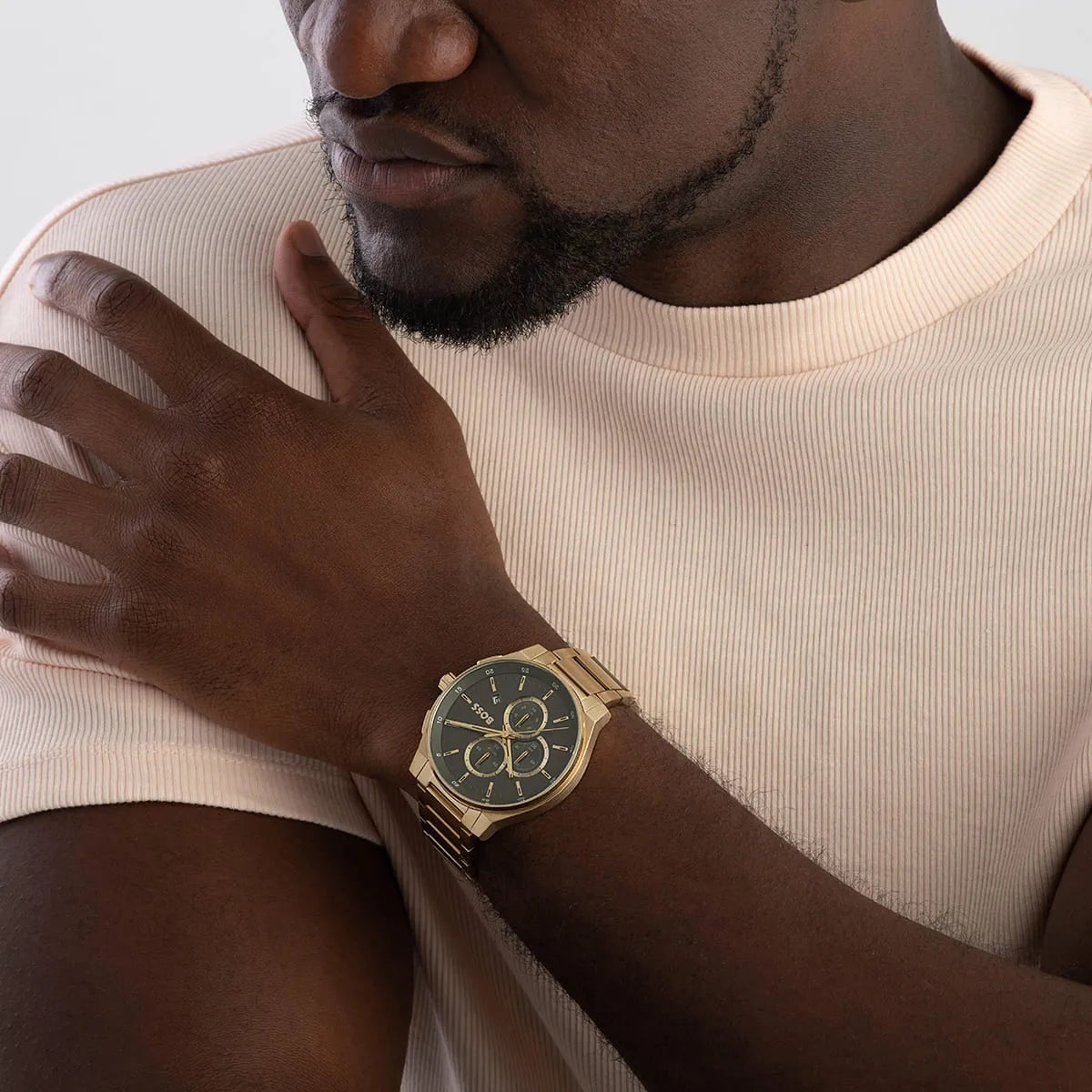 BOSS gold chronograph watch on wrist displaying three chronograph subdials