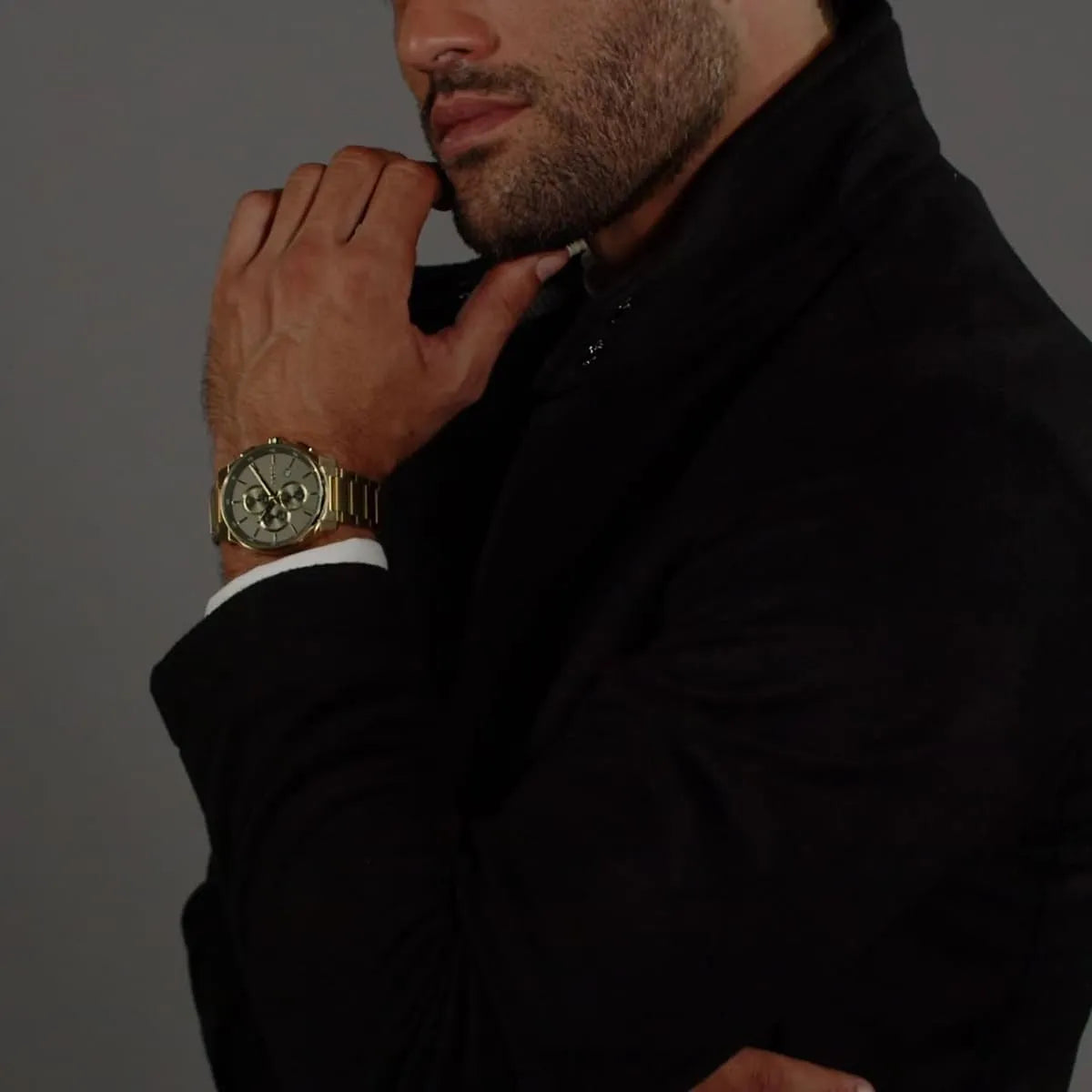 BOSS chronograph watch worn on wrist with olive green dial and gold steel bracelet