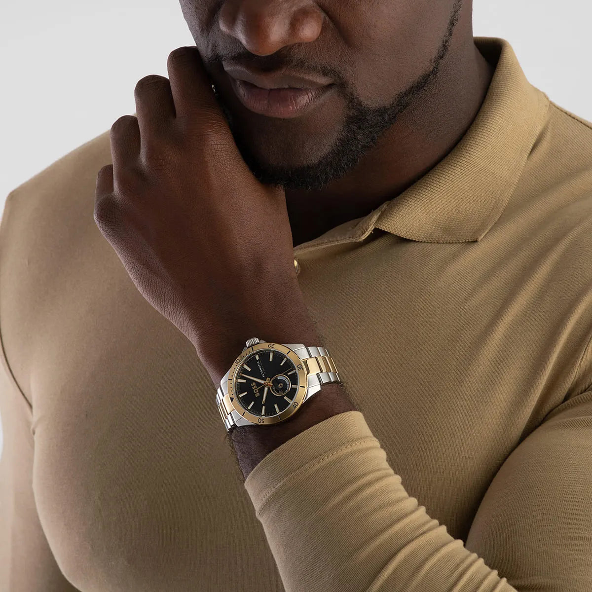 Hugo Boss Troper watch worn on wrist showing navy dial, gold bezel, and two-tone bracelet styling