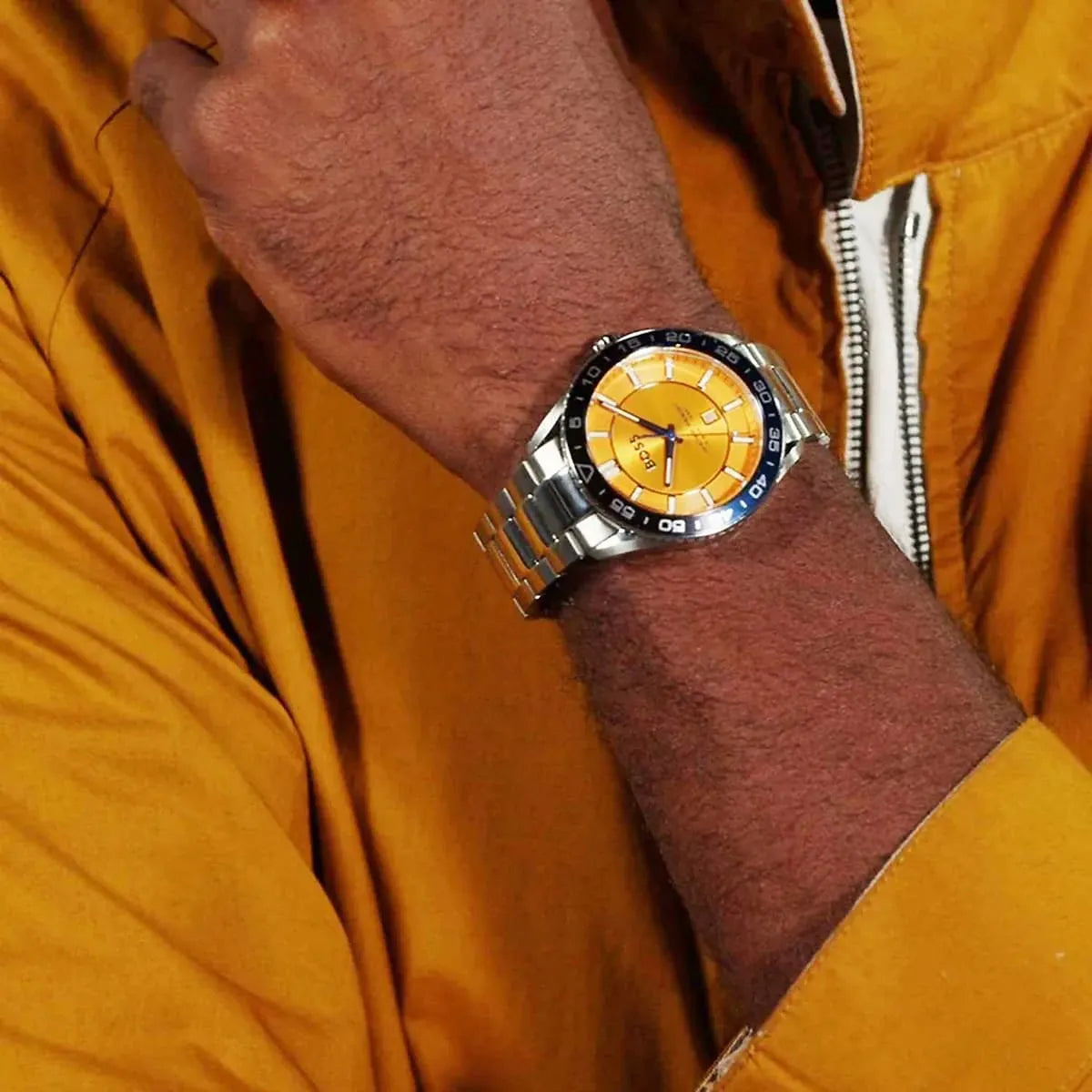 Hugo Boss Runner watch worn on wrist with orange dial visible