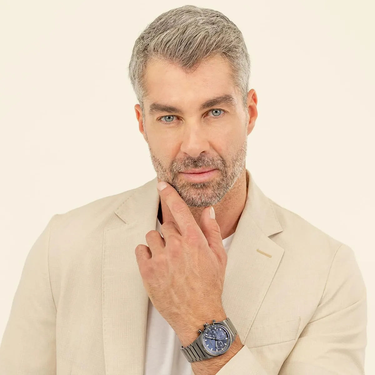 Man wearing Hugo Boss Candor Chrono watch with blue dial on stainless steel bracelet
