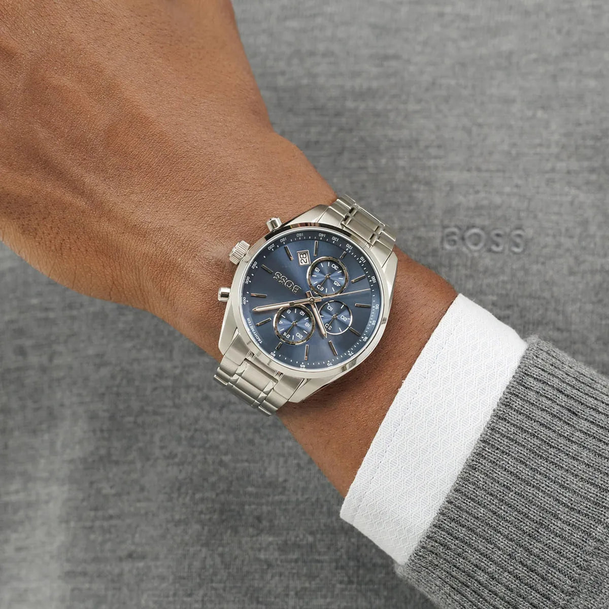 Hugo Boss Grand Prix chronograph watch worn on wrist showing blue dial and steel bracelet