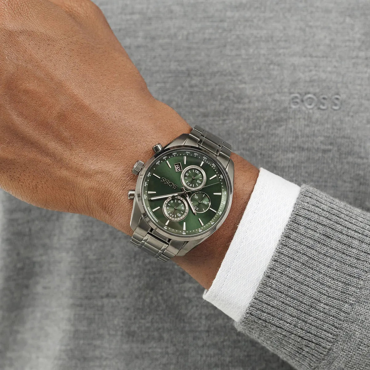 Hugo Boss Grand Prix chronograph watch worn on wrist showing green dial and metal bracelet