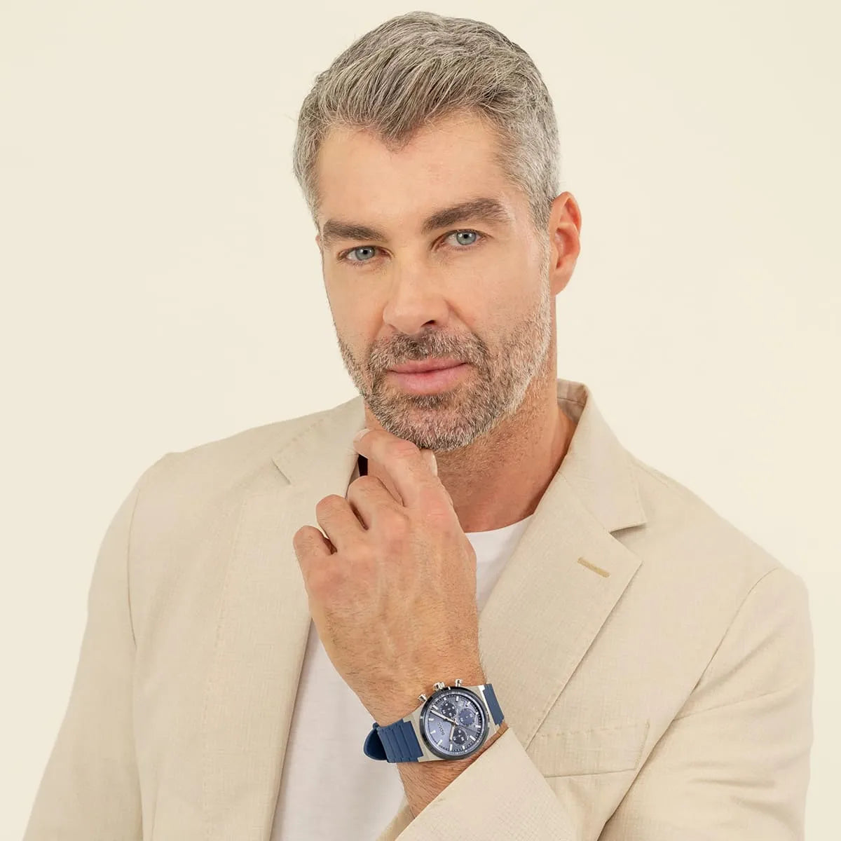 Man wearing Hugo Boss Candor chronograph watch with blue dial and blue rubber strap