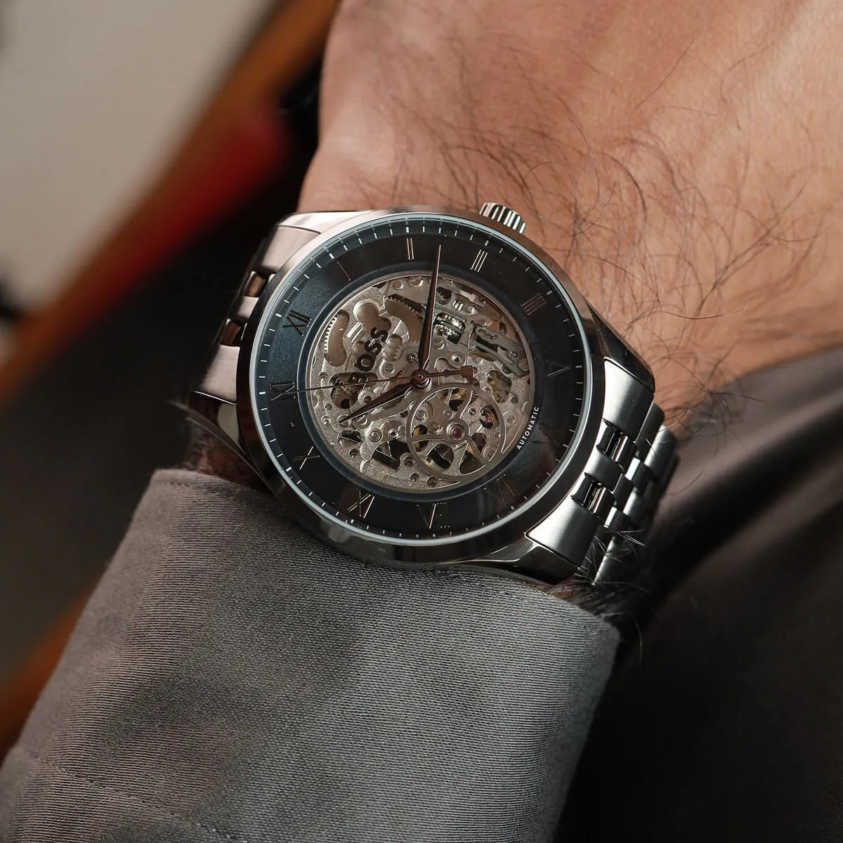 Hugo Boss Principle skeleton watch worn on wrist showing blue dial and skeleton movement