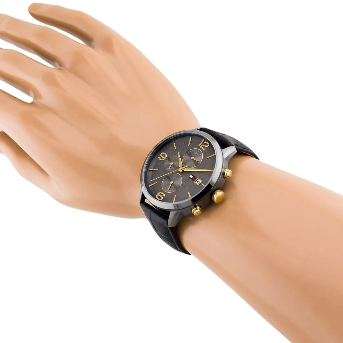Tommy Hilfiger Liam watch worn on wrist showing gray dial with chronograph subdials and black leather strap